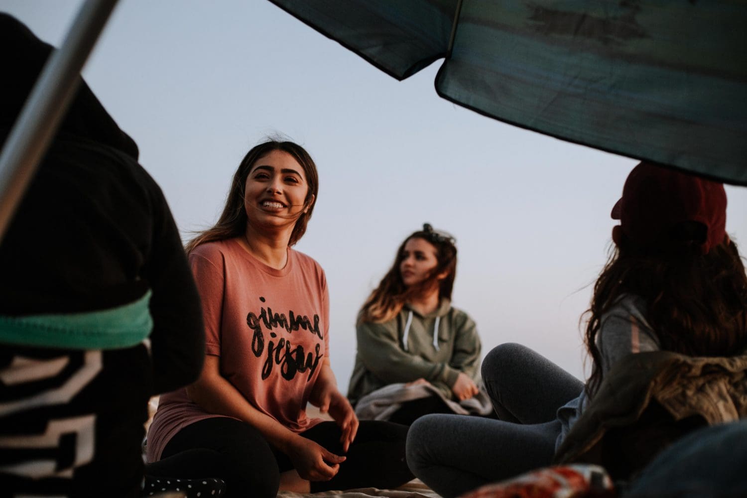 Latin Women seated in a circle, smiling